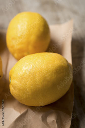 Close up of two lemons in a brown paper bag