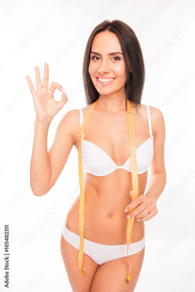 Cheerful slim woman with measuring tape gesturing Cheerful slim woman with measuring tape gesturing