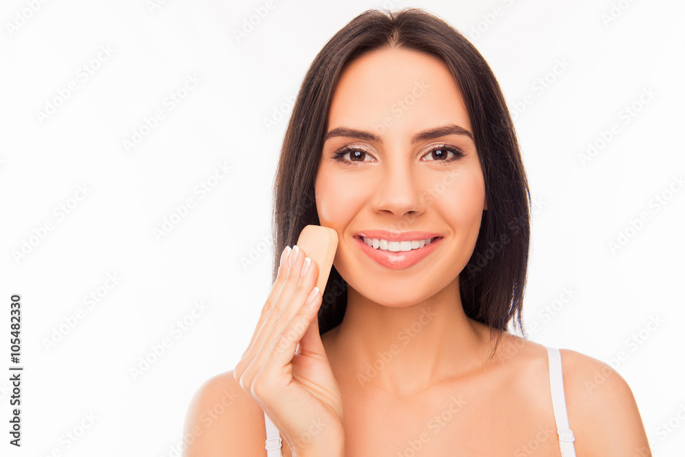 Beautiful girl evens skin tone of her face Beautiful girl evens skin tone of her face