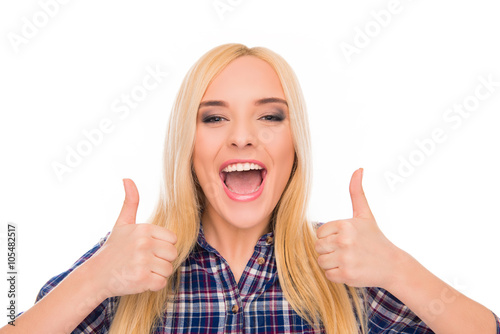 Attractive blonde with beaming smile showing thumbs up photo