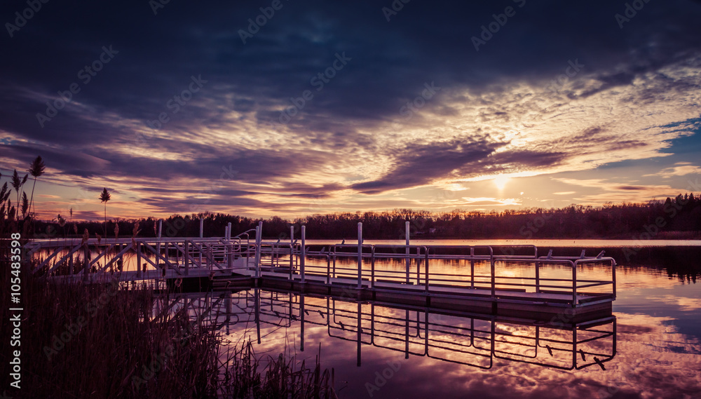 A dramatic sunset of deep purple and blue is seen at the dock of Owens Crossing, part of the Wallkill National Wildlife Refuge