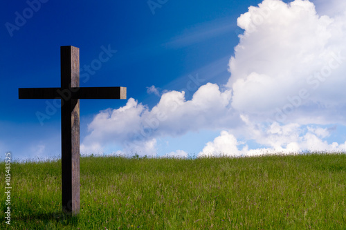 jesus christ cross. Easter resurrection concept. christian cross on spring background with blue sky, sunbeams, daylight.