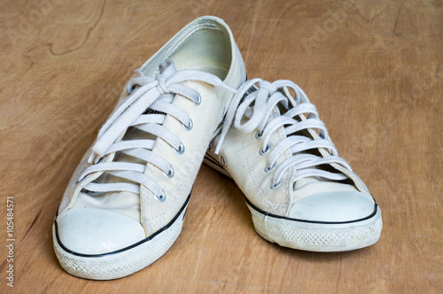 White sneaker on wood background