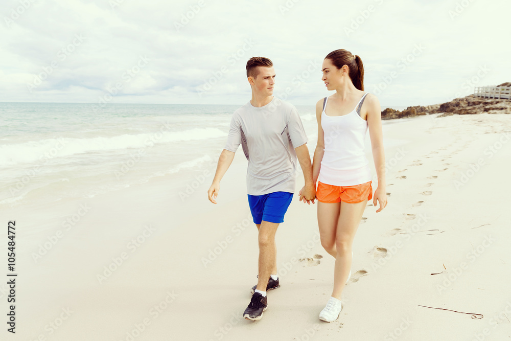 Runners. Young couple running on beach Runners. Young couple running on beach