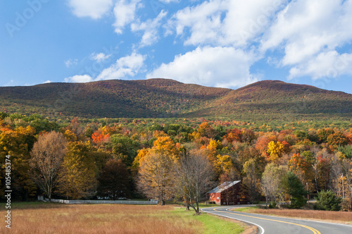Fall foliage in upstate New York, Hudson Valley. Winding country road through the Catskill mountains.