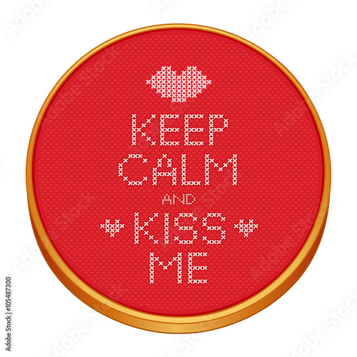 Keep Calm and Kiss Me cross stitch embroidery on wood embroidery hoop with love, a big kiss and hearts, red Aida even-weave cloth texture background needlework sampler isolated on white.