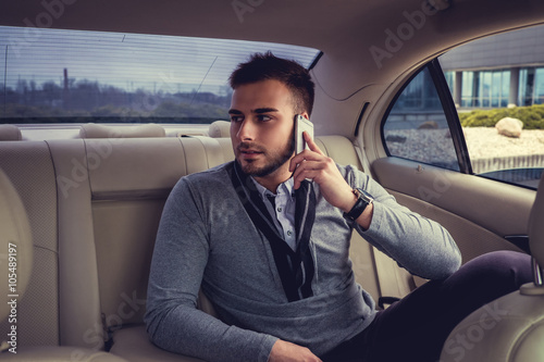 A man talking by smartphone in the car. © Fxquadro