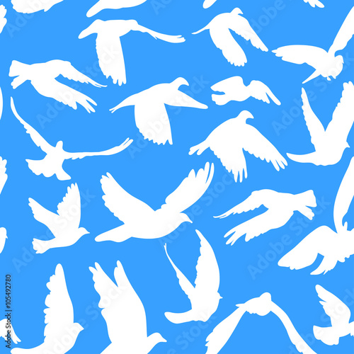 Doves and pigeons seamless pattern on blue background for peace concept and wedding design.