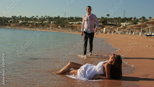 Bride and groom sexually kissing on the beach. Honeymoon in Egypt