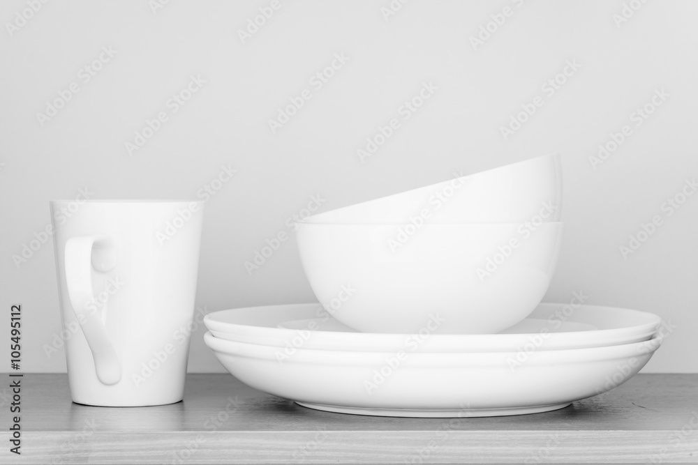 Fototapeta premium White coffee cup and white bowl in kitchen cabinet