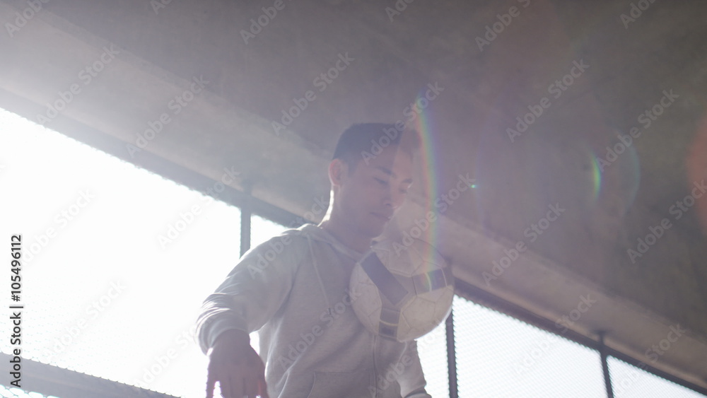 Handheld shot of soccer freestyle player doing tricks with the football