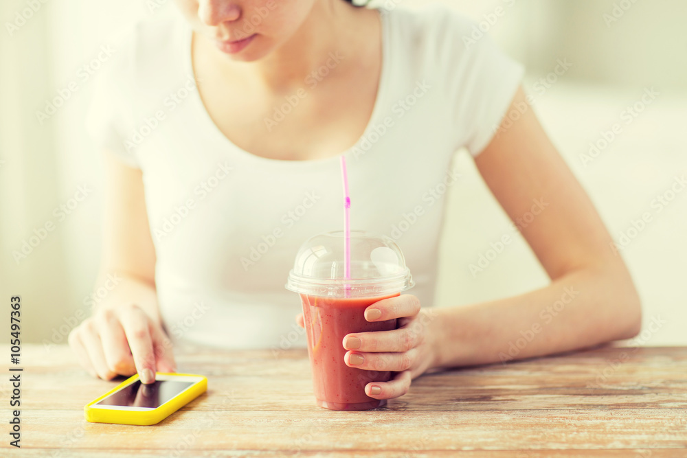 close up of woman with smartphone and smoothie close up of woman with smartphone and smoothie