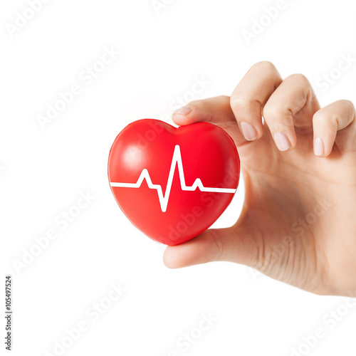 close up of hand with cardiogram on red heart