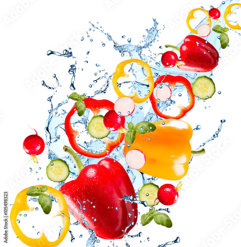 Water splash with vegetable isolated on white backgroud. Fresh pepper, cucumber photo