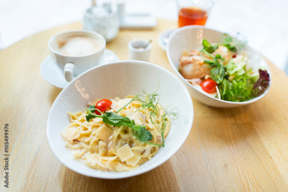 close up of pasta in bowl on table at restaurant