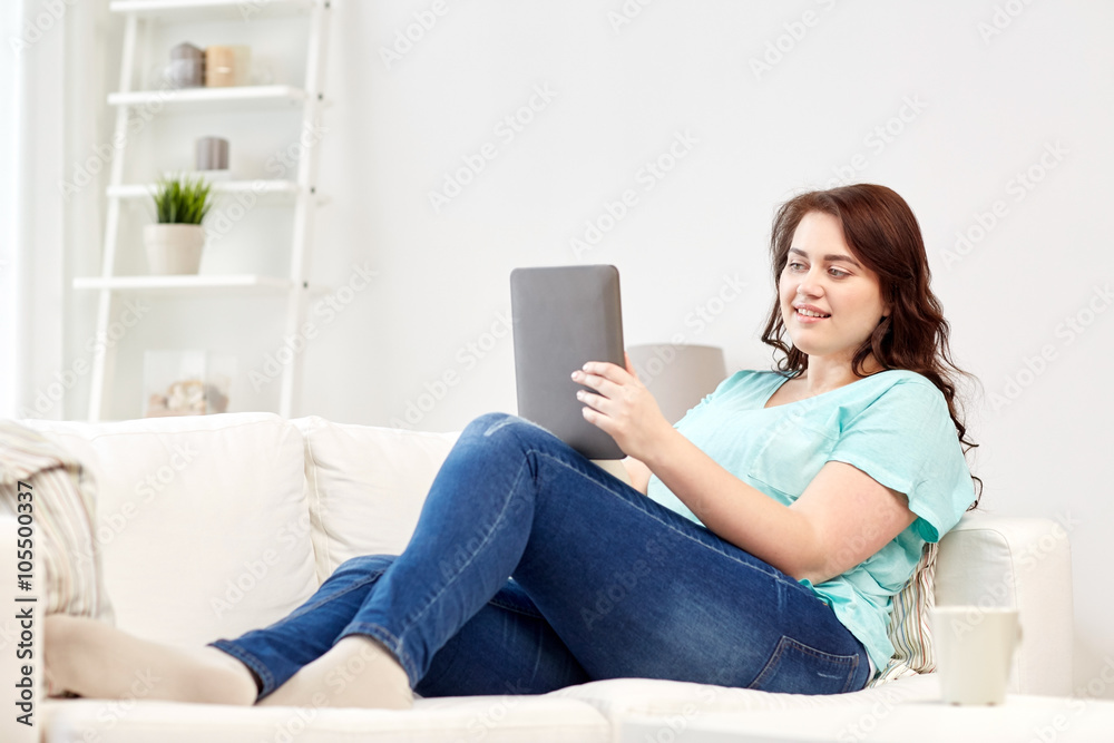 happy young plus size woman with tablet pc at home happy young plus size woman with tablet pc at home