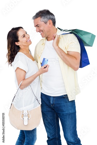 Portrait of happy couple with shopping bags and credit card