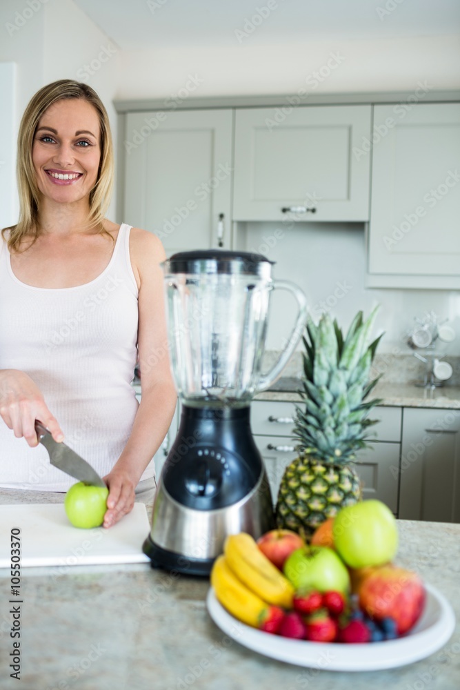Pretty blonde woman preparing a smoothie Pretty blonde woman preparing a smoothie