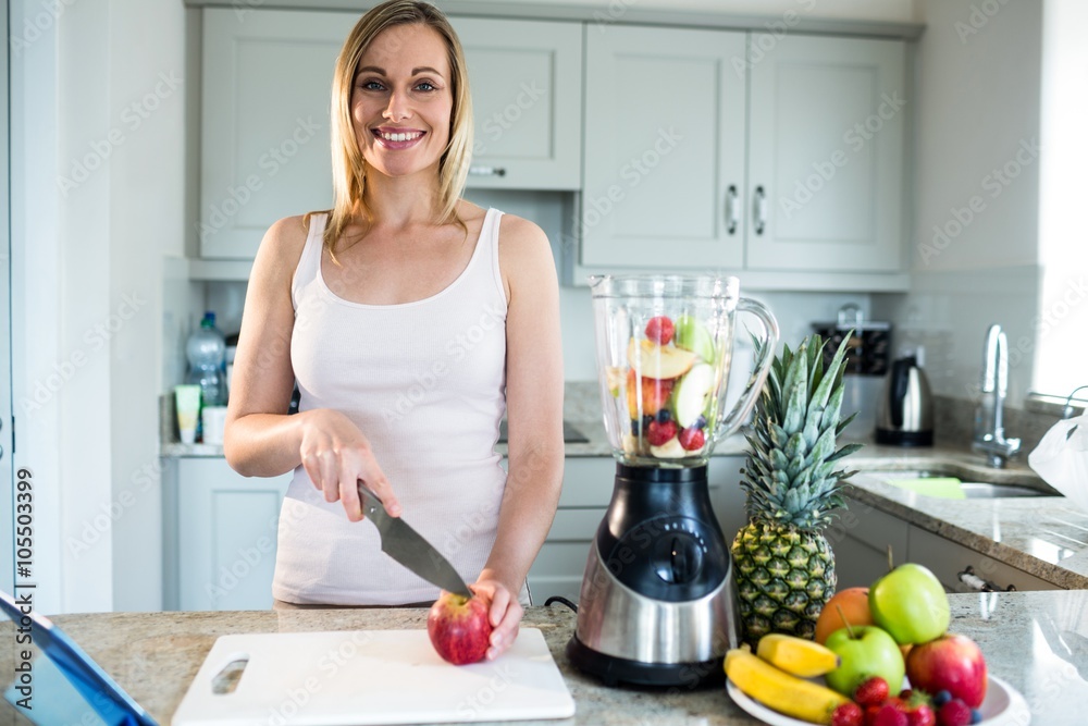 Pretty blonde woman preparing a smoothie Pretty blonde woman preparing a smoothie