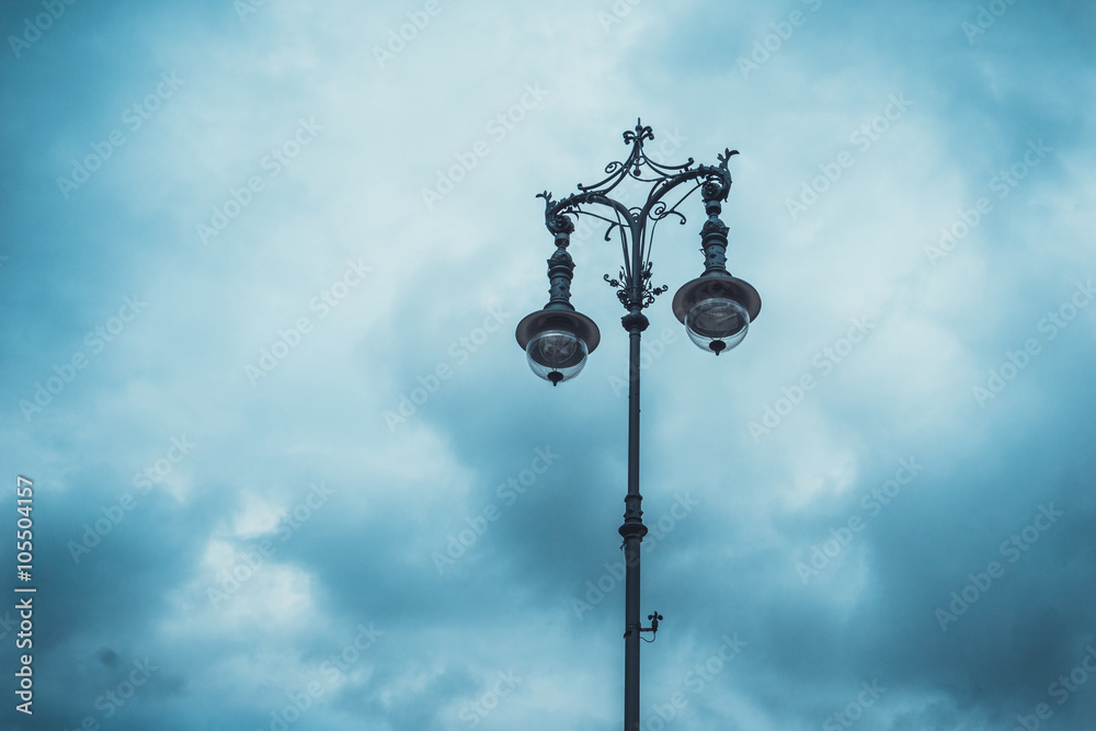 Old iron street light made of two lamps on a pole Old iron street light made of two lamps on a pole