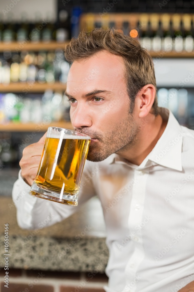 Handsome man drinking beer