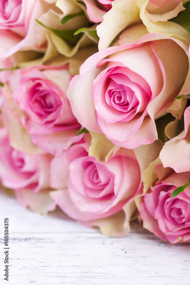 Bouquet of pink roses with blue ribbon for present on a vintage wooden background, closeup. Bouquet of pink roses with blue ribbon for present on a vintage wooden background, closeup.