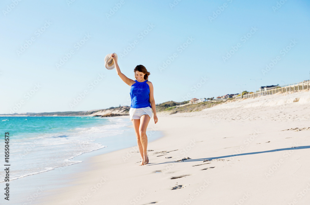 Young woman walking along the beach