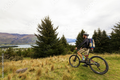 Fototapeta Naklejka Na Ścianę i Meble -  Mountain bike rider at Lake Wanaka, New Zealand
