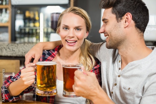 Couple toasting with beers
