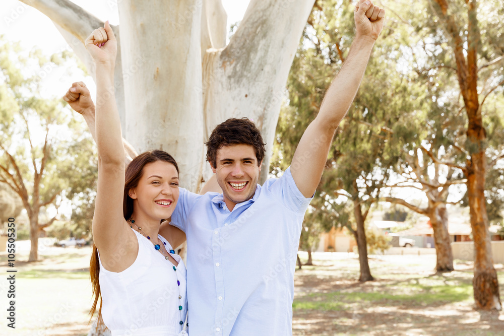 Young couple in the park celebrating Young couple in the park celebrating