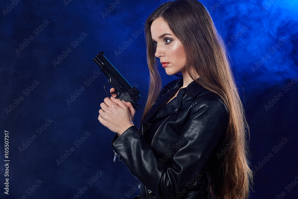 beautiful sexy girl holding gun . smoke background beautiful sexy girl holding gun . smoke background