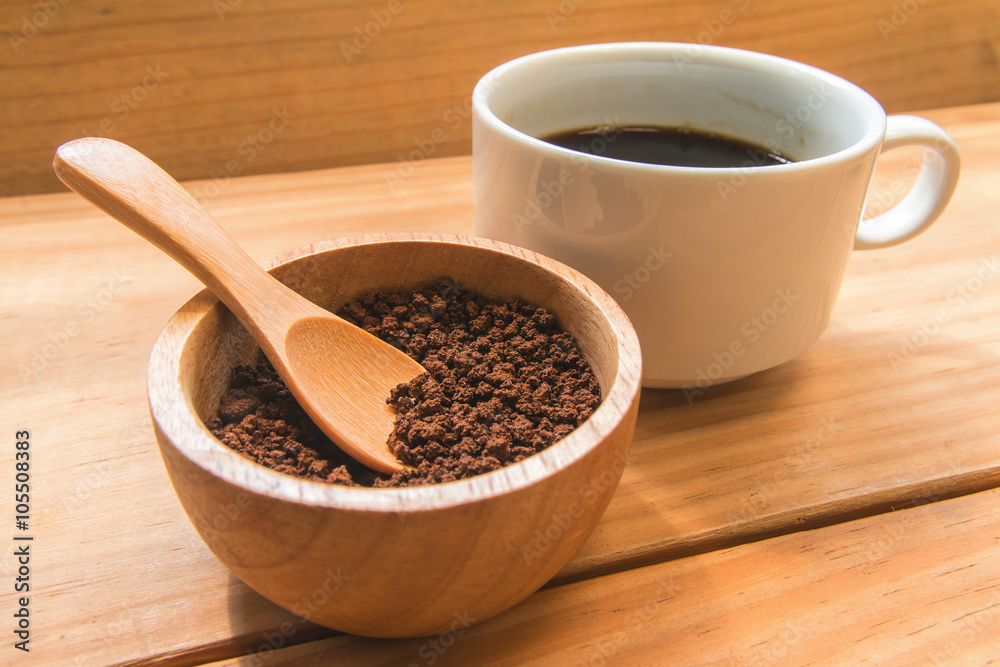 Instant coffee in the wood bowl with white cup of coffee Instant coffee in the wood bowl with white cup of coffee