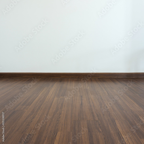 empty room, white mortar wall background and wood laminate floor © sutichak