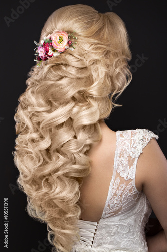 beautiful blond girl in image of the bride with purple flowers on her head. Beauty face. Hairstyle back view