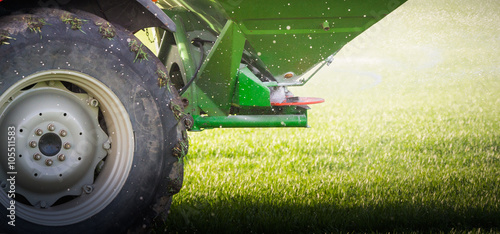  tractor fertilizing in field photo