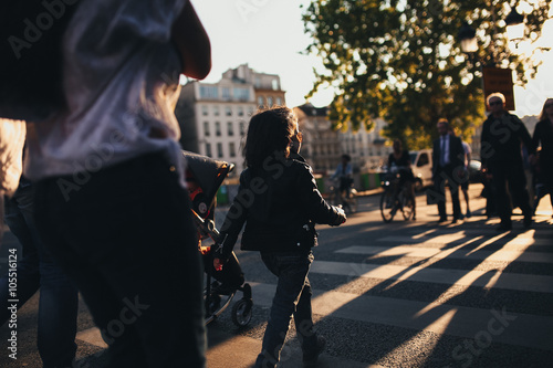 young family moving along the street