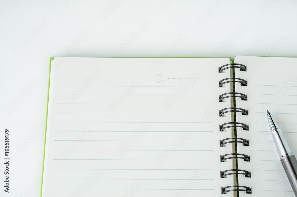 Open notebook with metallic ball pen Open notebook with metallic ball pen