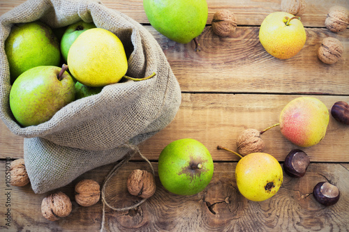 Autumn composition of fruits, nuts and spices - pears, walnuts, maple leaves