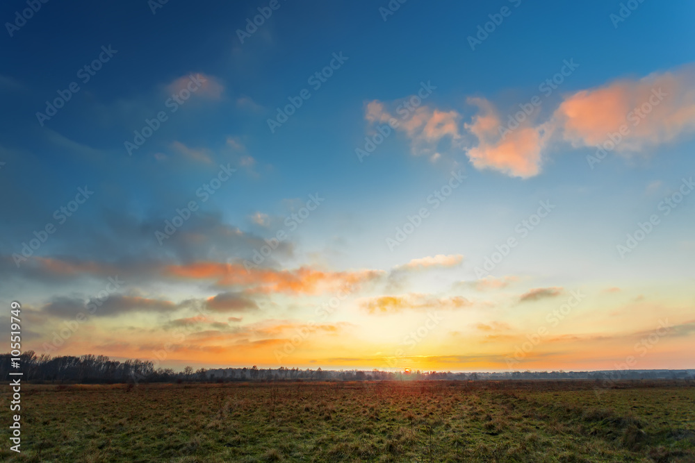 Sunset in a field, spring season landscape Sunset in a field, spring season landscape