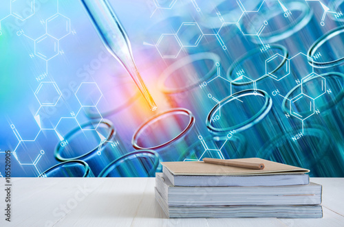 book stack on white table with science laboratory test tubes bac