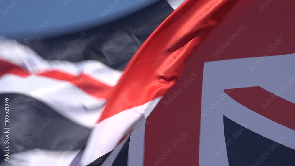 British flag blowing in wind with blue sky background, Britain