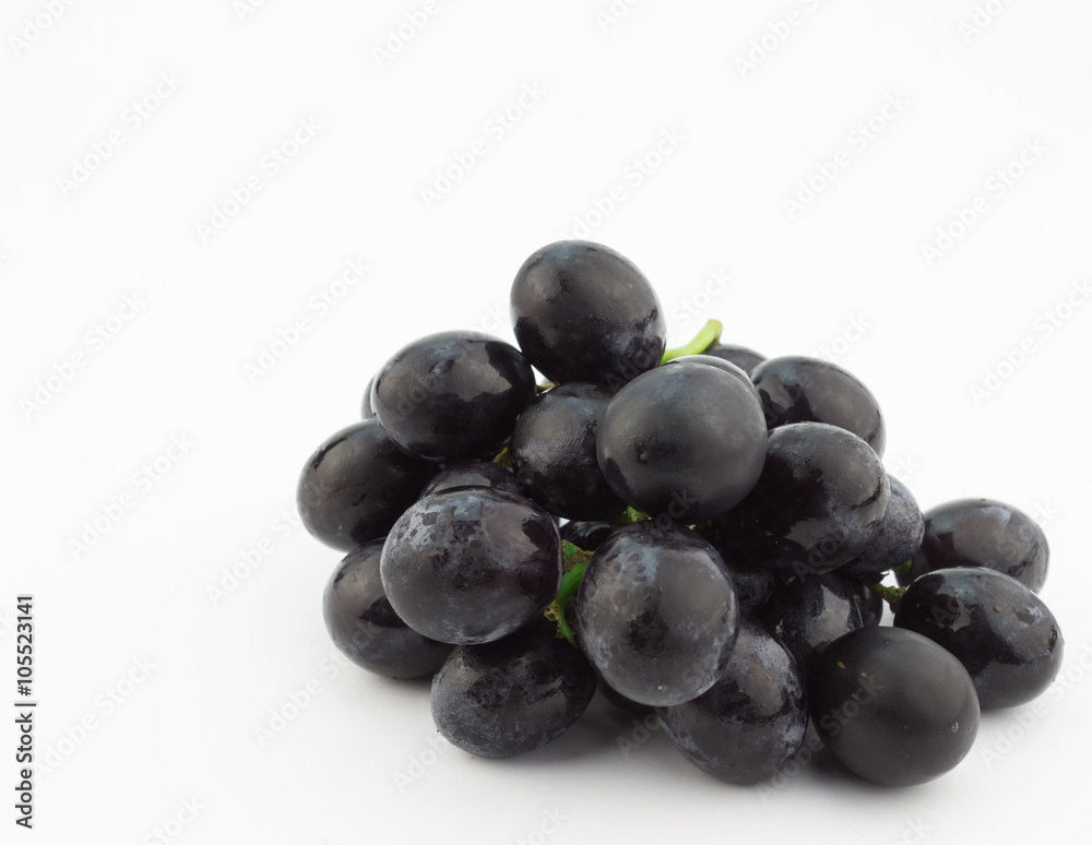 Small bunch of black grapes isolated on white background Small bunch of black grapes isolated on white background