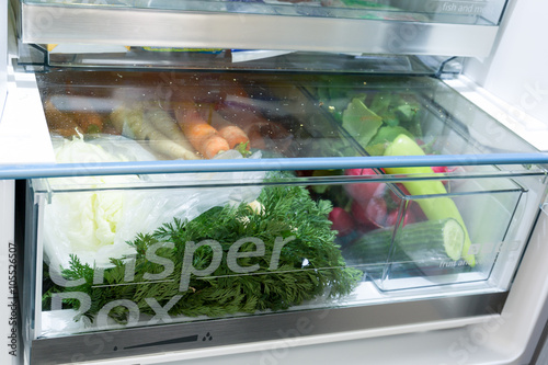 Open fridge filled with vegetables