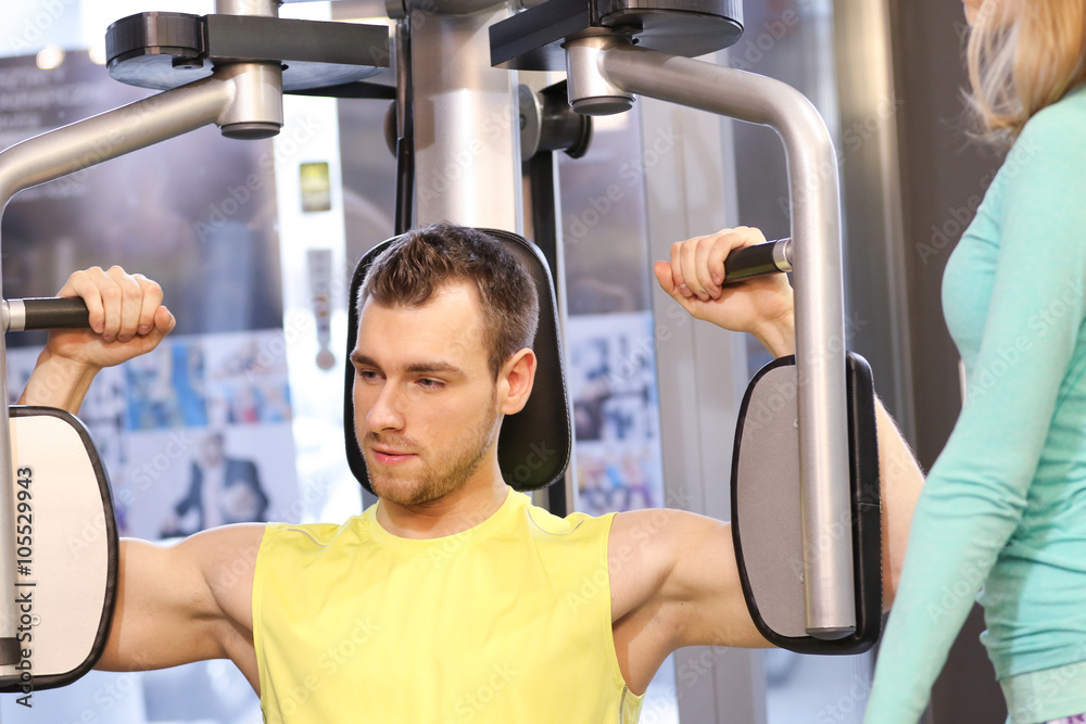 Young handsome muscled man during workout Young handsome muscled man during workout