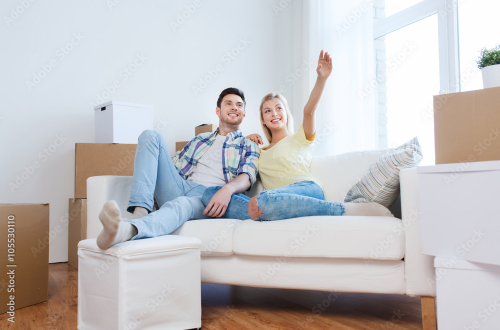 couple with boxes moving to new home and dreaming couple with boxes moving to new home and dreaming