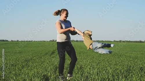 mom turns the young son outdoors. Slow motion. Toning for instagram filter