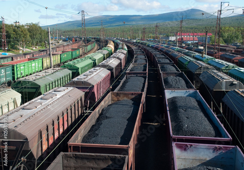 Cars with coal and oil on cargo railway station