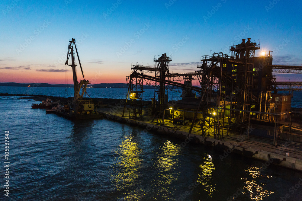 Panorama image of the illuminated cargo port in Crimea at night