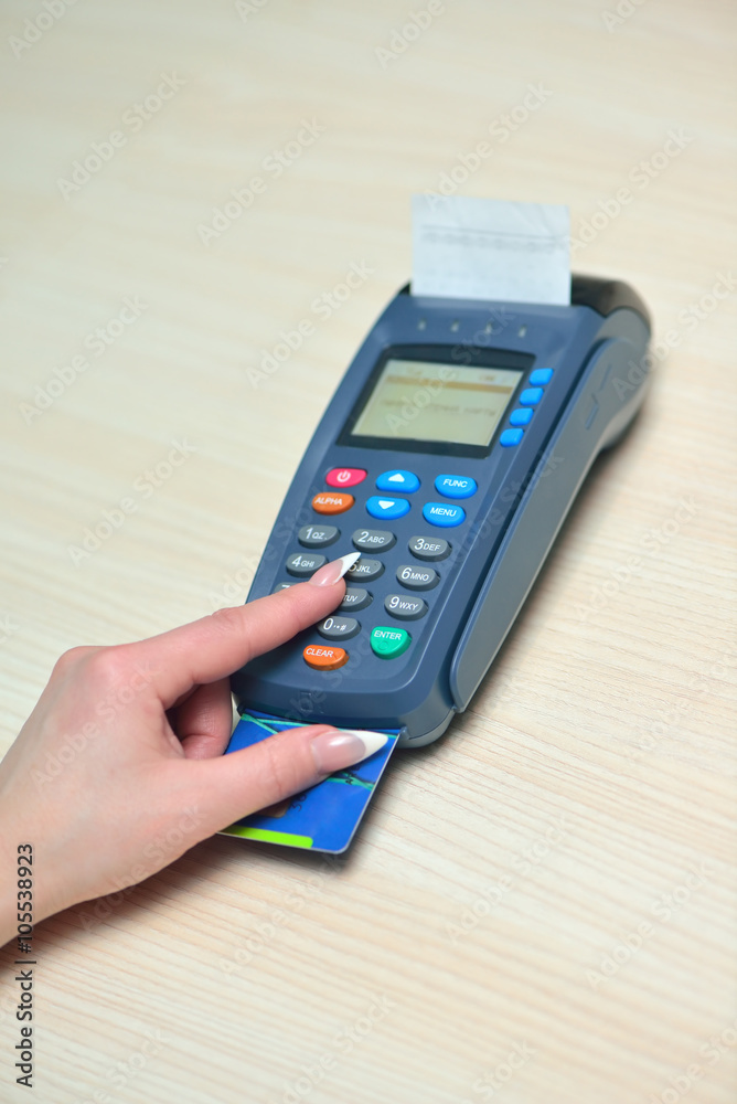 Girl pays purchase through the terminal pos Girl pays purchase through the terminal pos