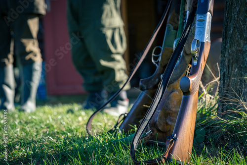 Picture of rifle in front hunters. Selective focus.